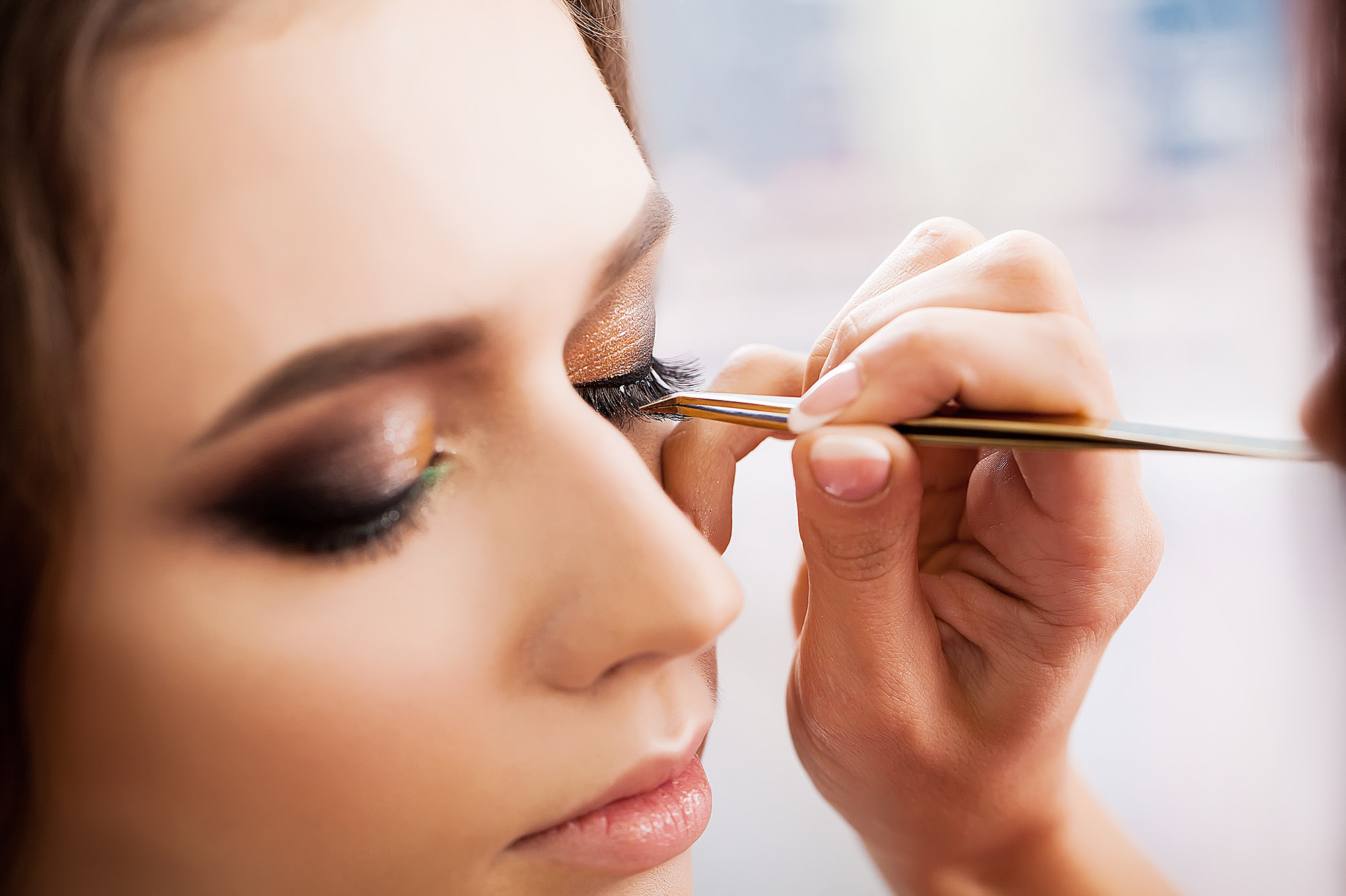 photo of a woman getting her eye makeup done