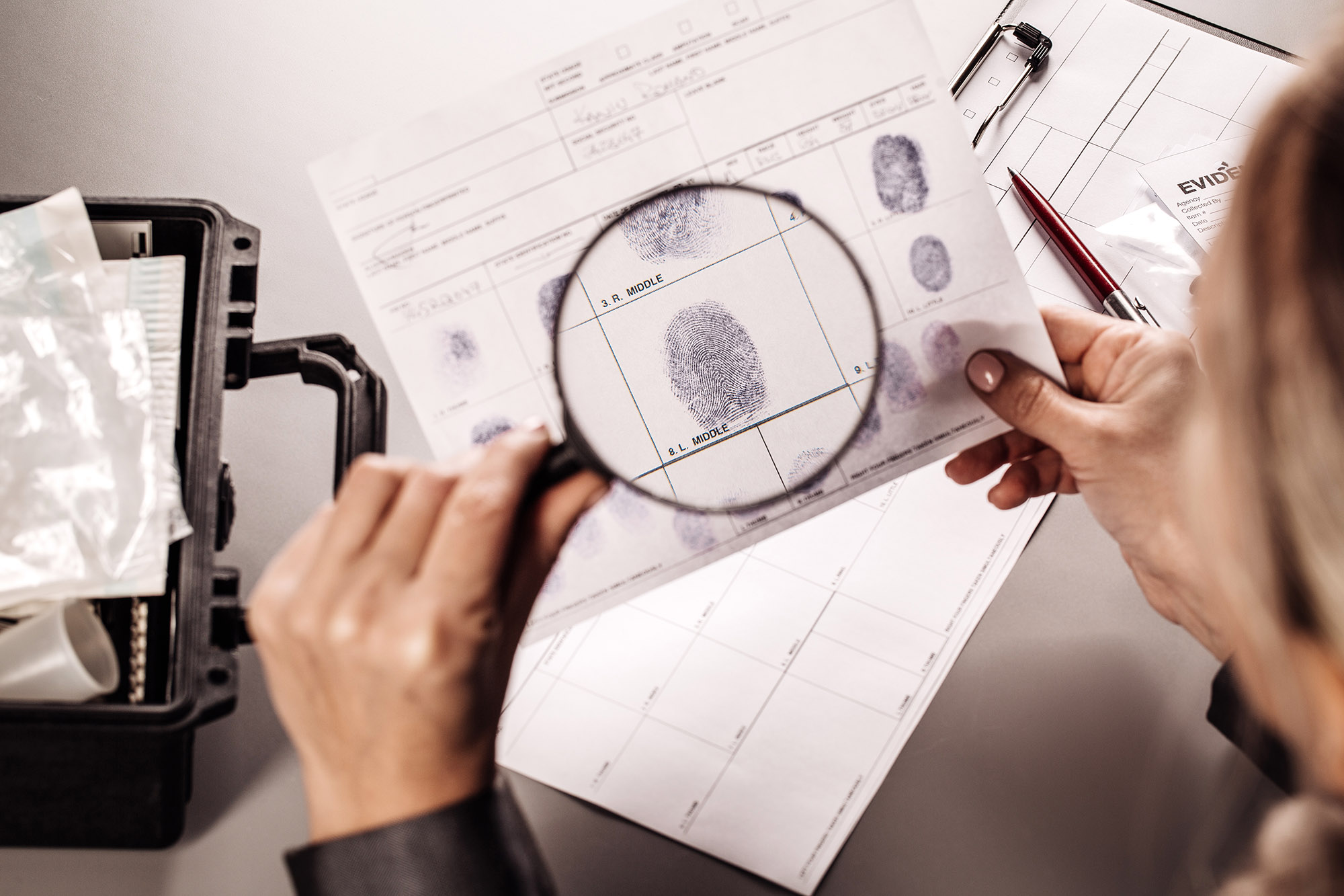 photo of woman inspecting fingerprints