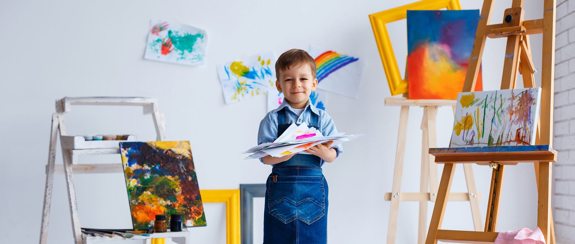 picture of a young child painting at an easel
