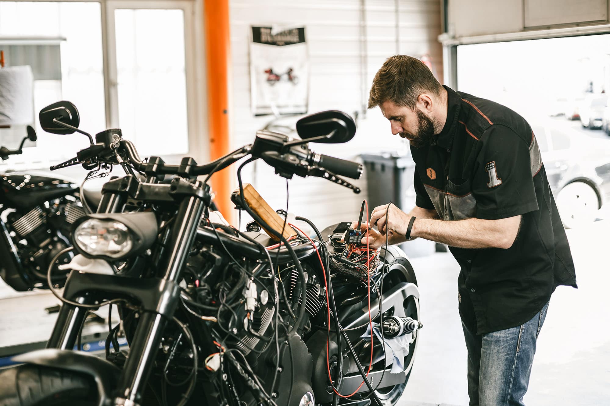 picture of a man fixing a motorcycle in a garage