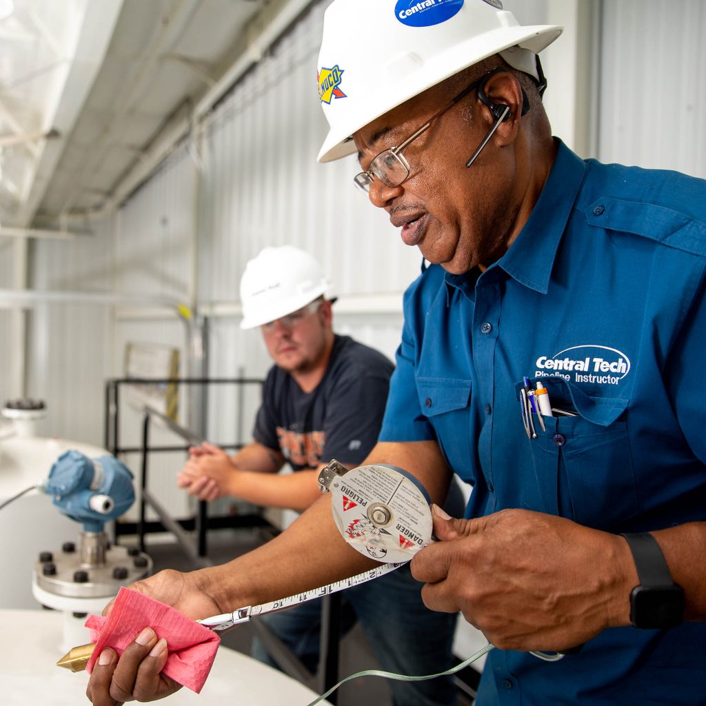 photo of man taking oil measurements at Central Tech