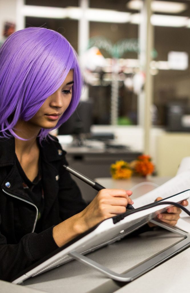 picture of a girl with purple hair learning graphic design at Central Tech in Drumright OK