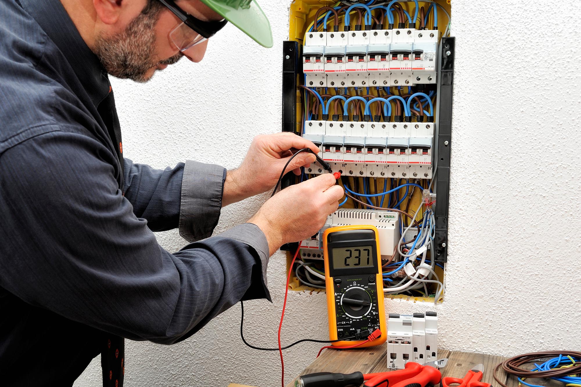 picture of a man working on an electrical breaker