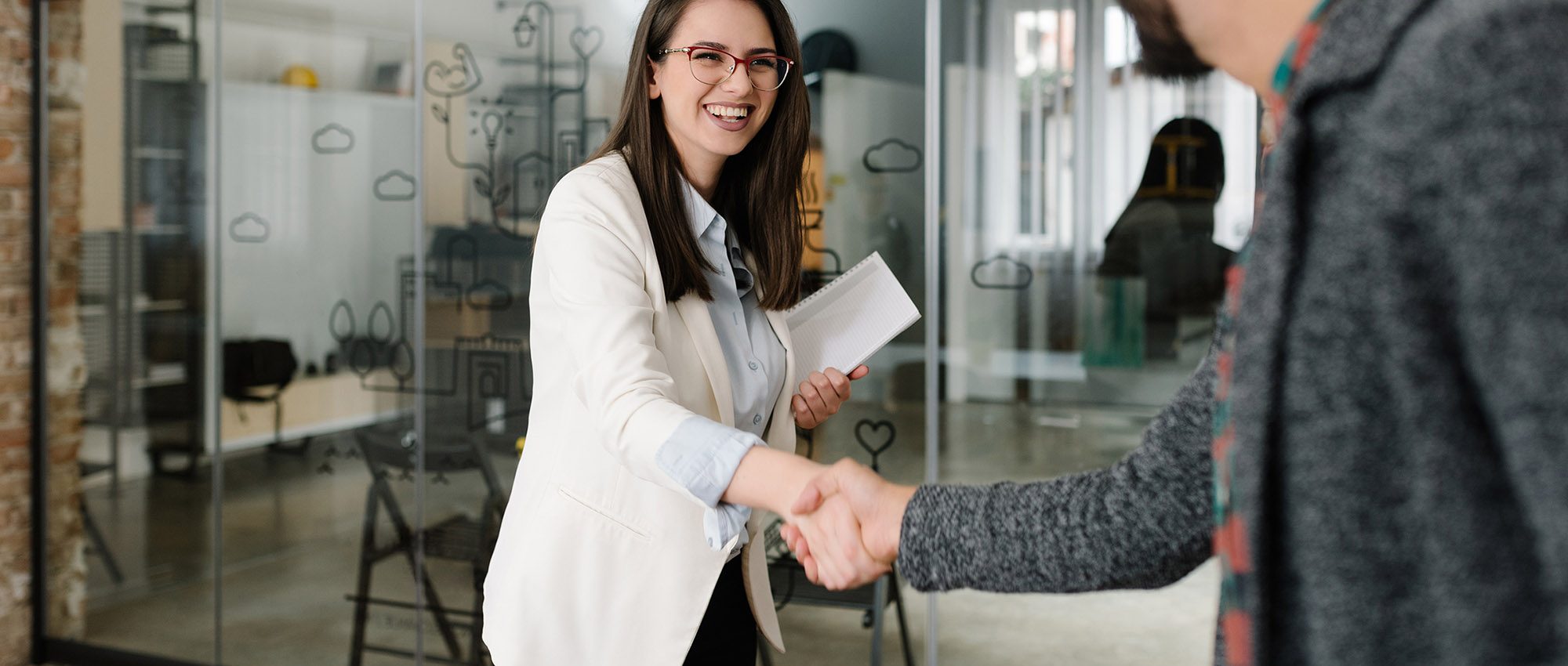 photo of a woman shaking a mans hand at a job interview