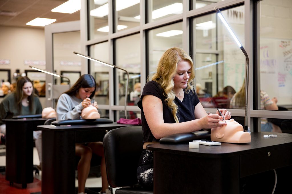 Central Tech cosmetology students applying fake eyelashes