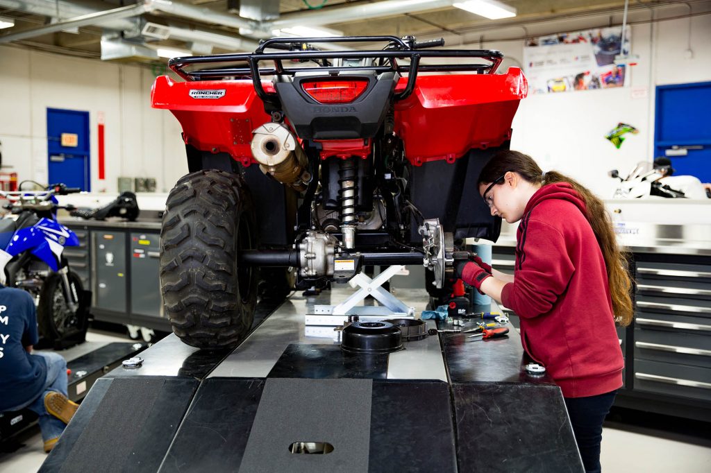 Central Tech student repairing a four wheeler