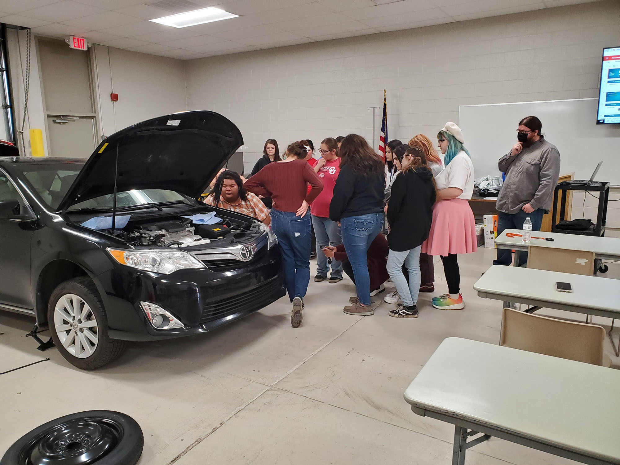 Cosmetology students at Central Tech learn car maintenance from Diesel students