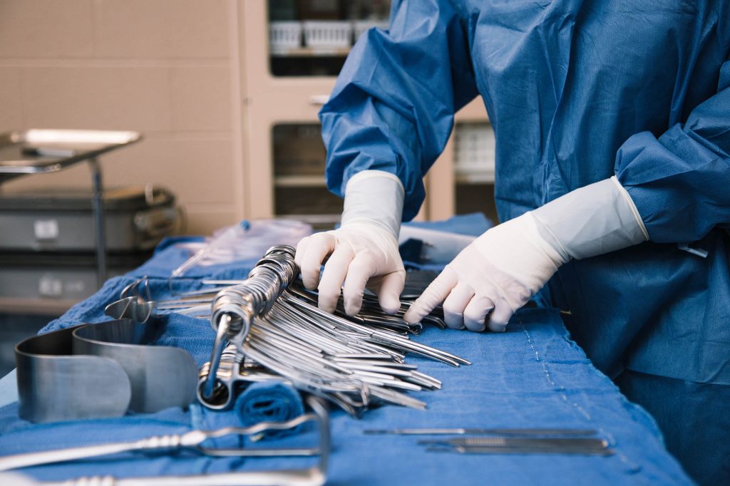 Surg Tech student counting instruments at Central Tech