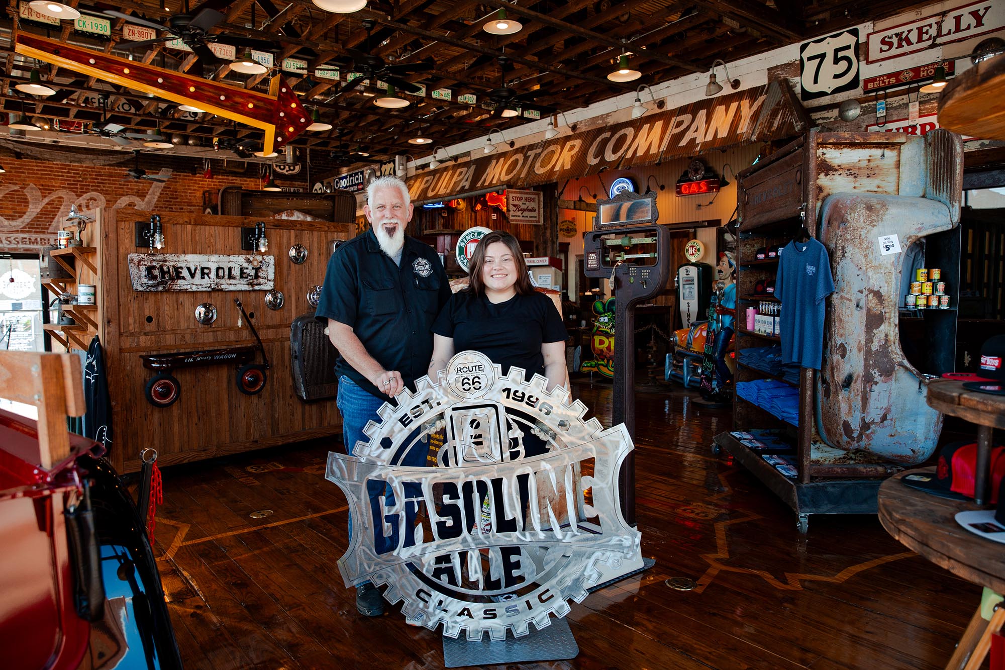 Welding student Champaign Walker presents metal sign to Gasoline Alley in Sapulpa