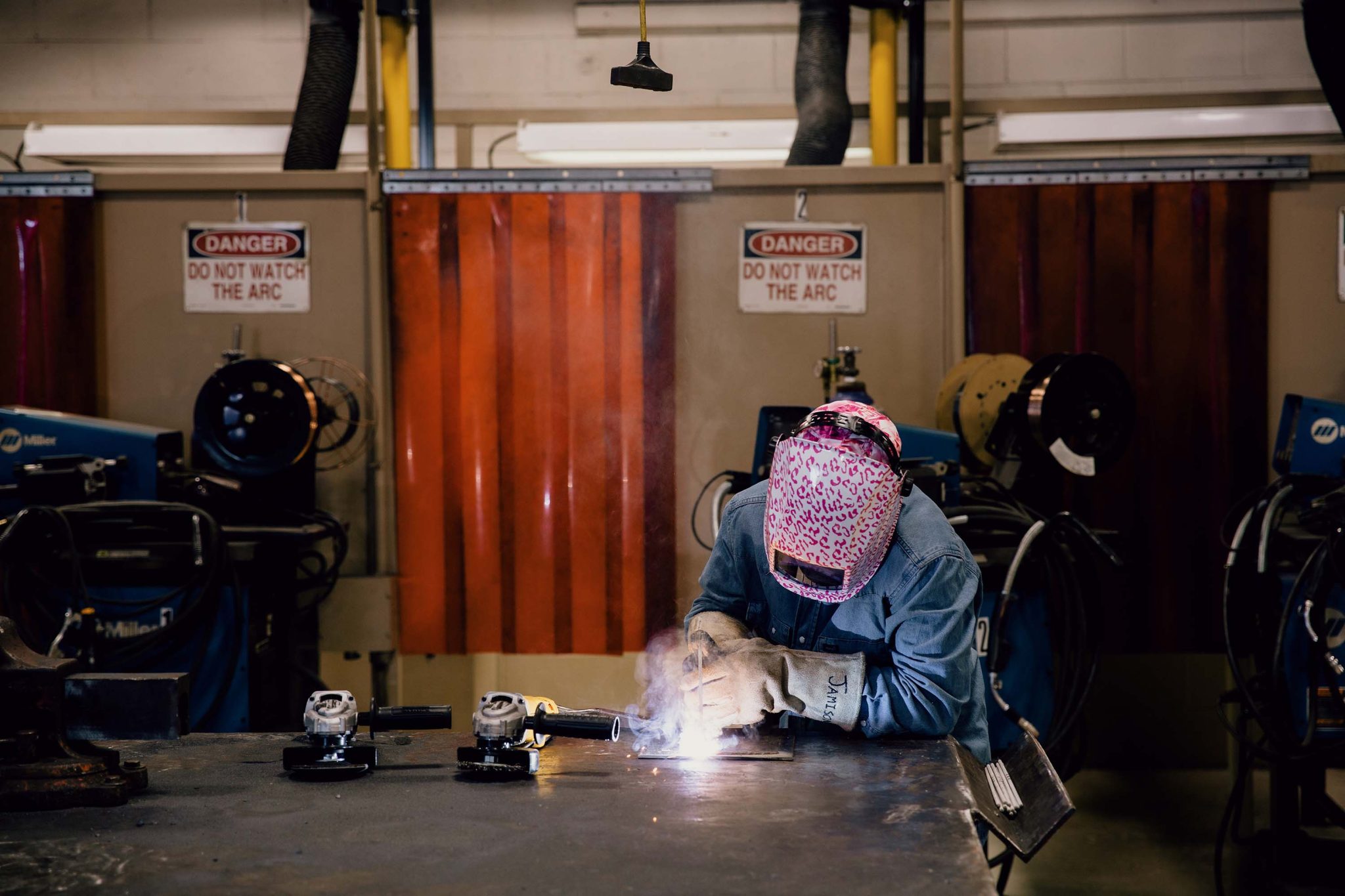 female student welding at Central Tech