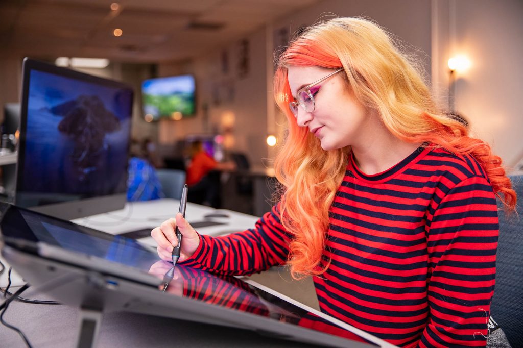 graphic designer with orange hair drawing