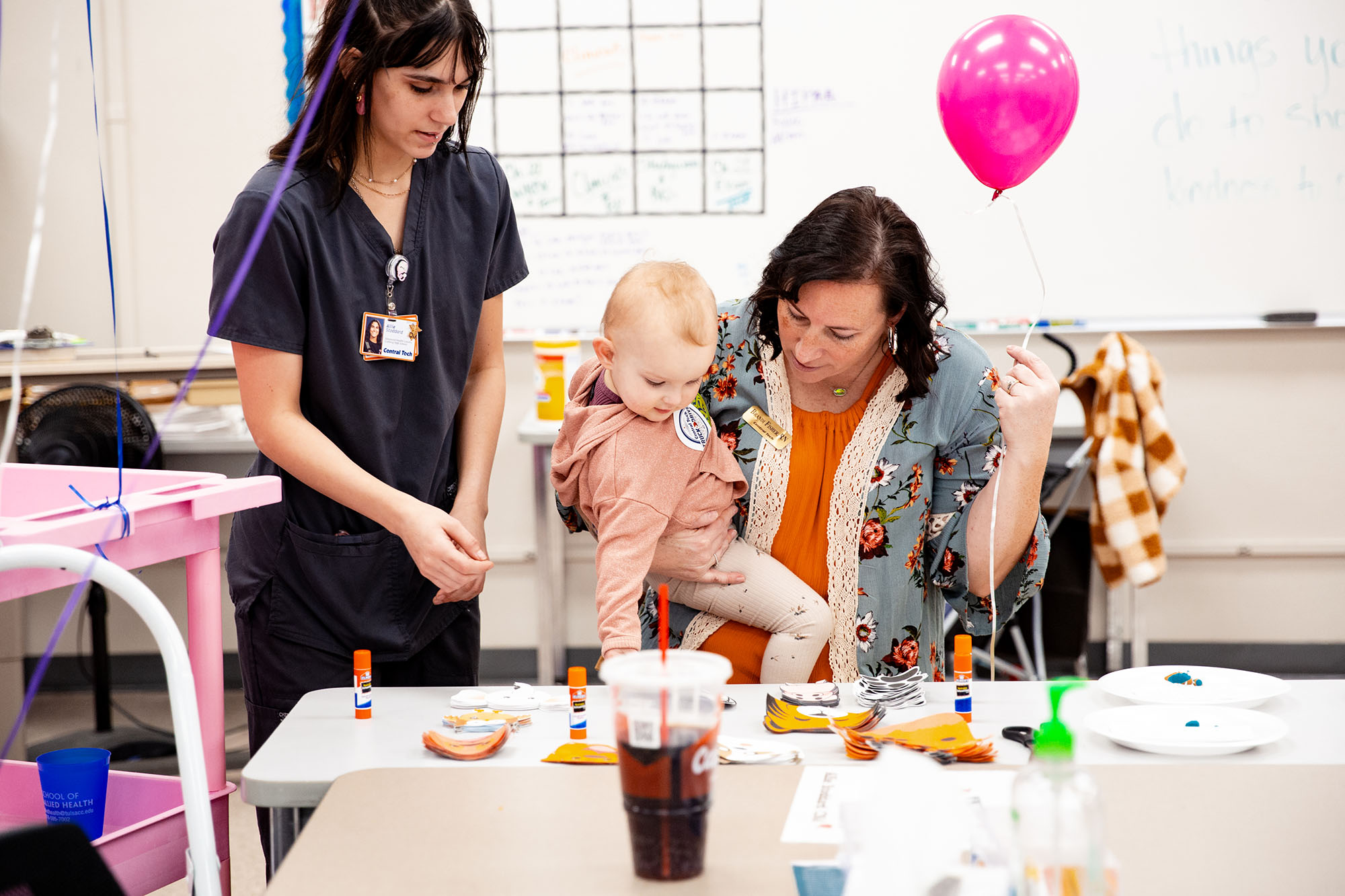 nurse holding child and balloon at Central Tech's Open House