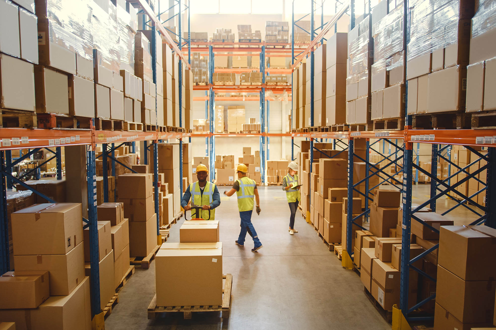 people moving boxes in a warehouse