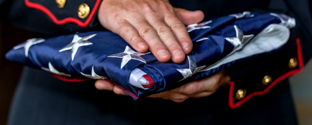 person holding folded flag