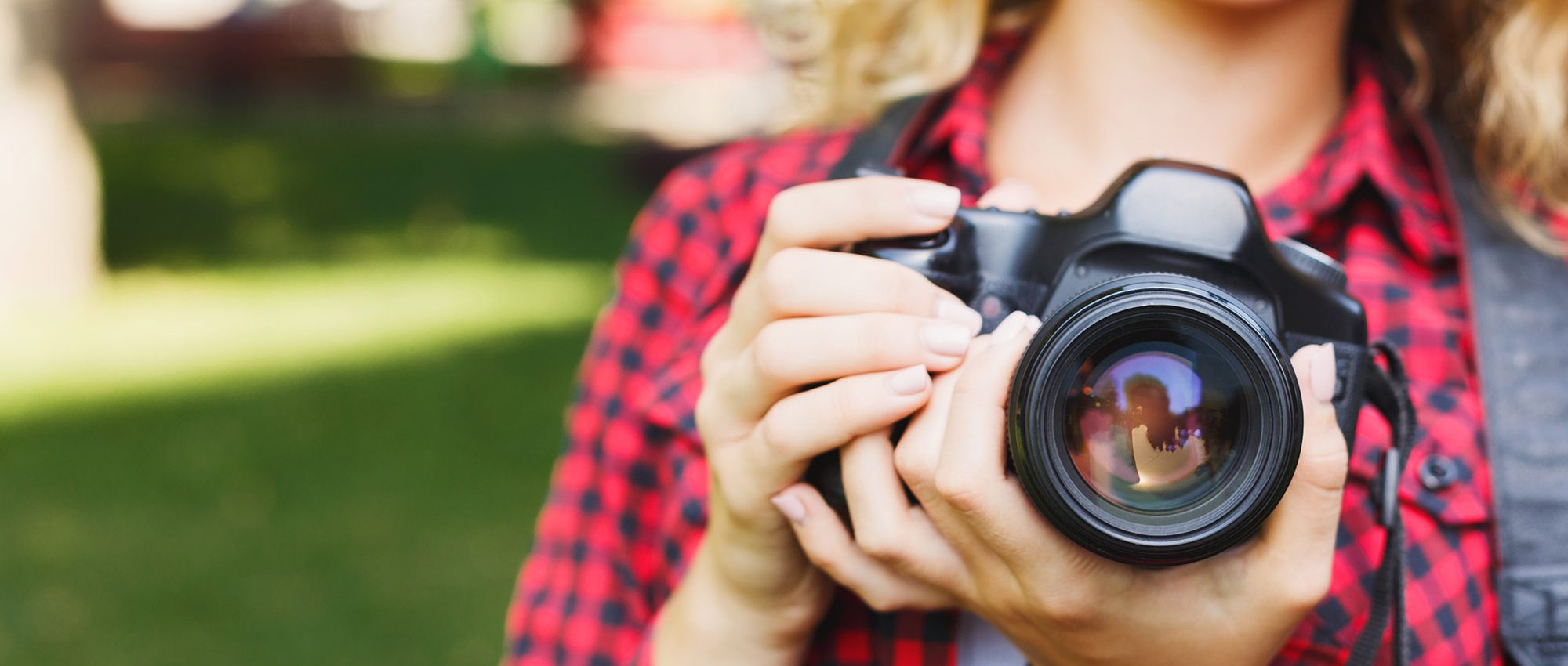 photo of a woman holding a camera