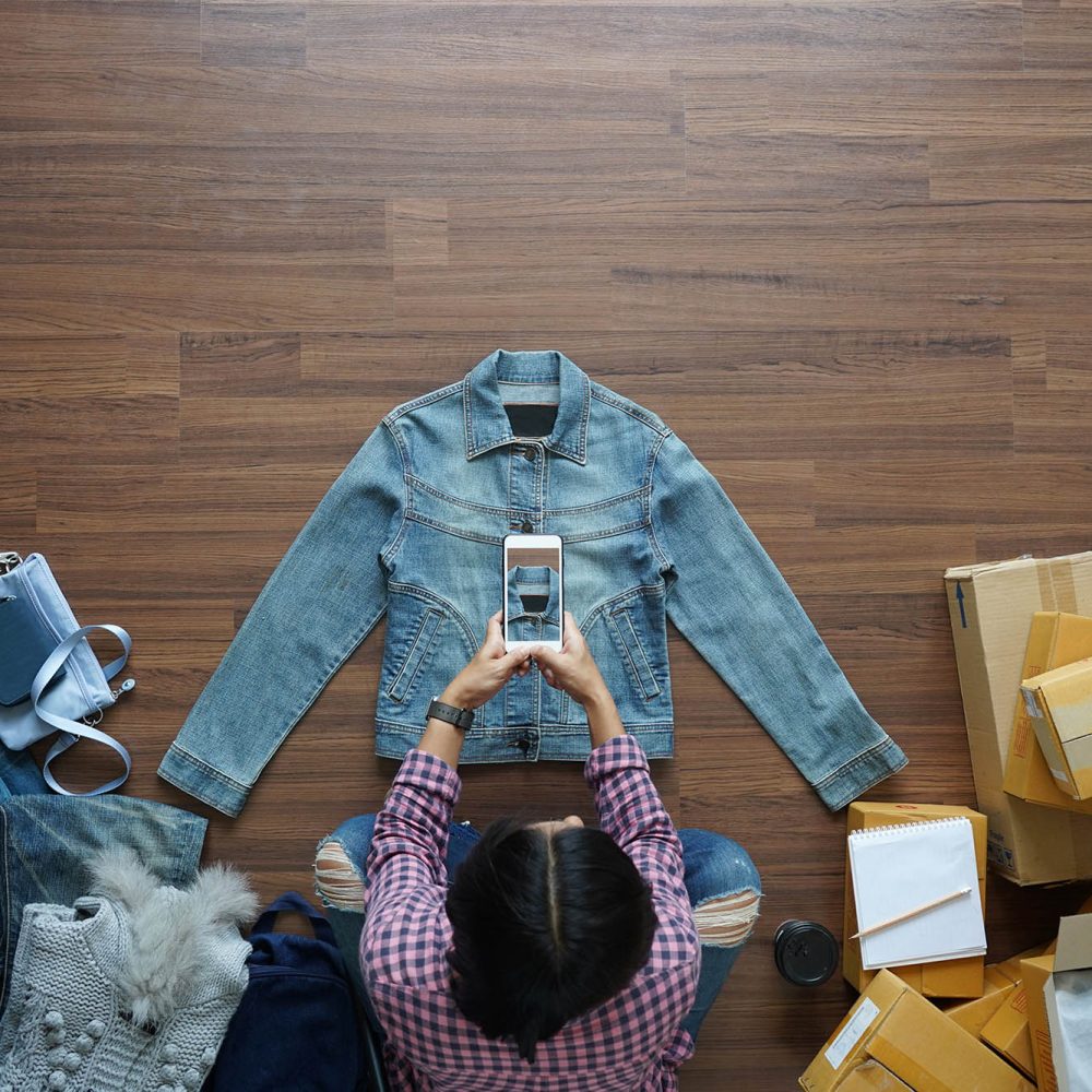 photo of a woman taking a picture of her products to sell