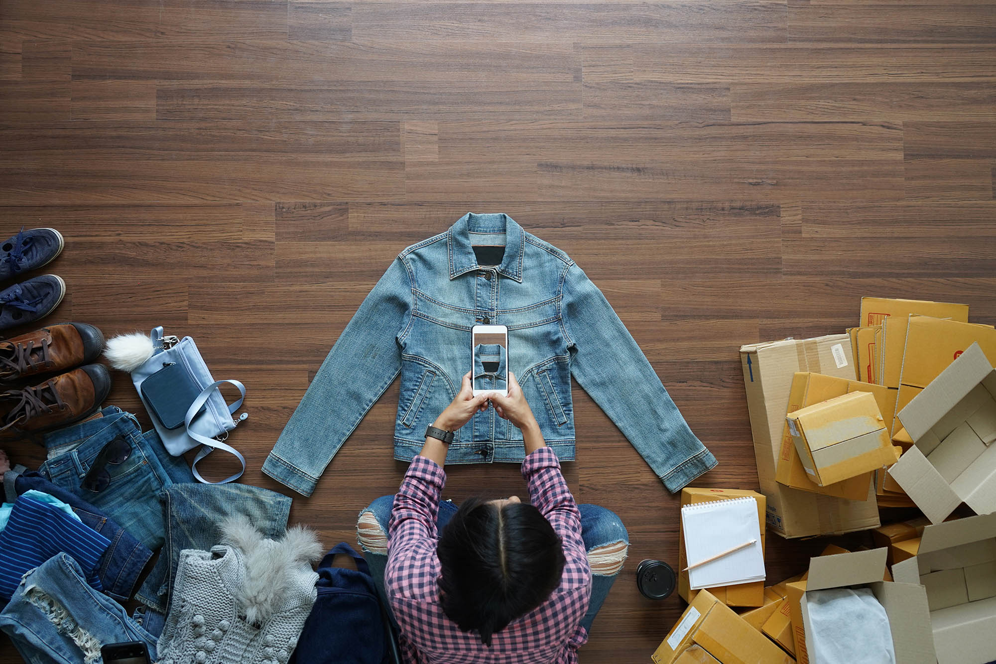 photo of a woman taking a picture of her products to sell