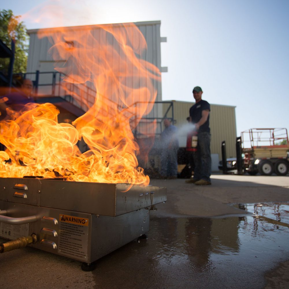 photo of fire fighter putting out a fire at Central Tech