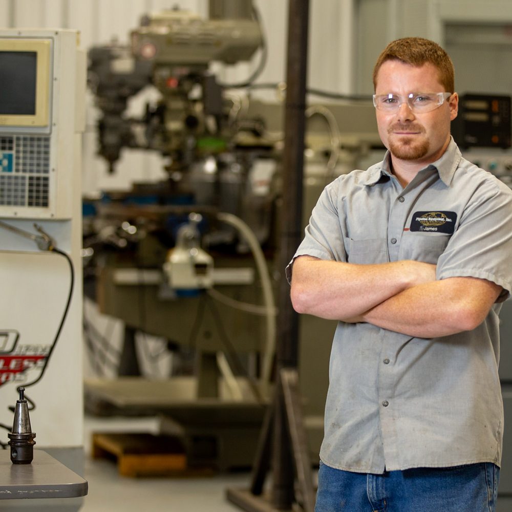 picture of man in safety goggles in a manufacturing position at Central Tech