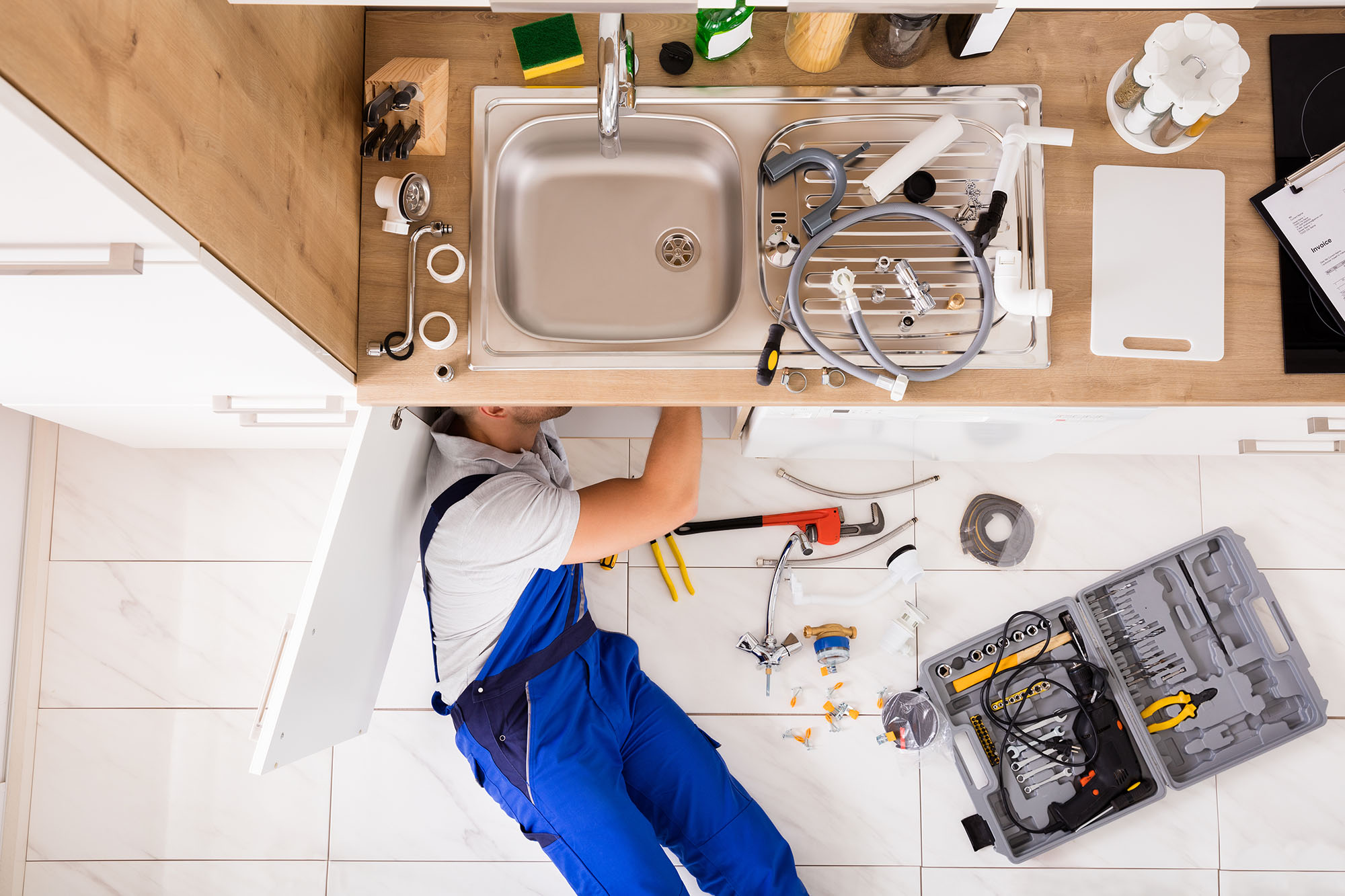 picture of plumber under a kitchen sink