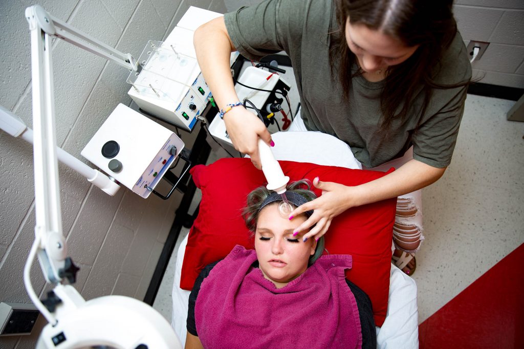 student giving a facial at the Central Tech cosmetology class