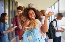 students hugging and celebrating