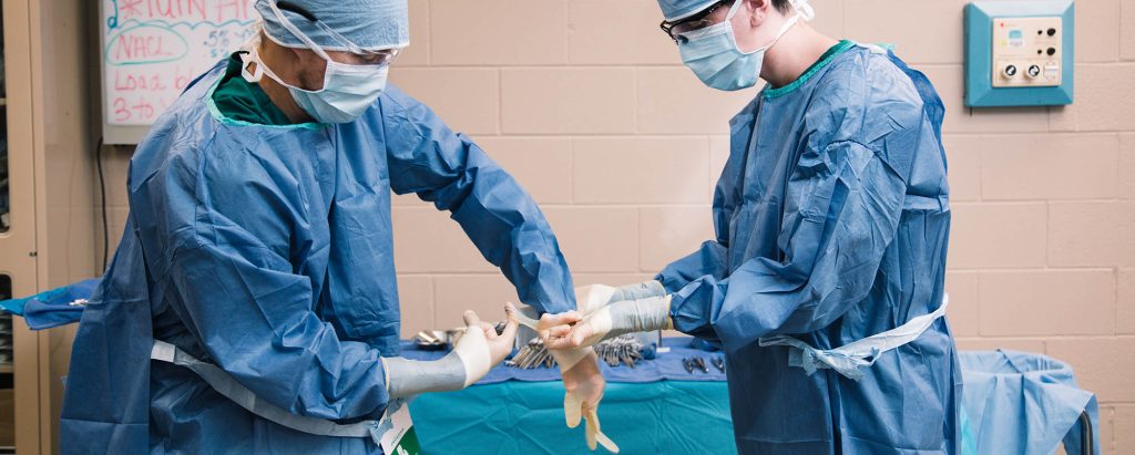 surgical technologist students at Central Tech gloving up